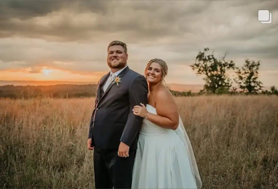 Сouple wearing a white gown and a black suit