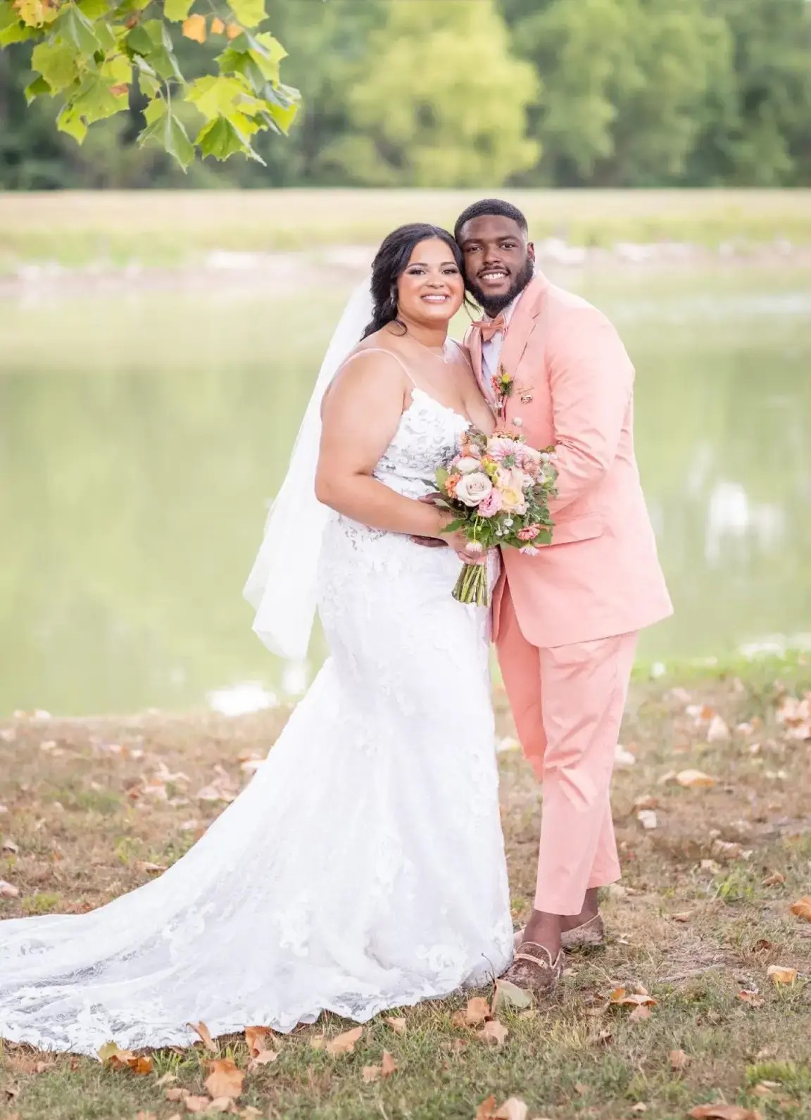 Сouple wearing a white gown and a black suit